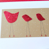 photo of holiday card with three red birds