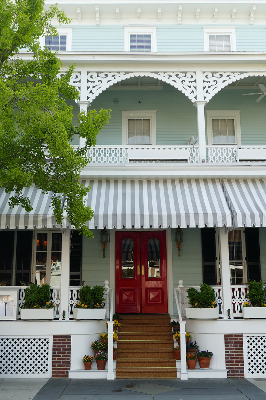 green and white victorian home in cape may nj with red door